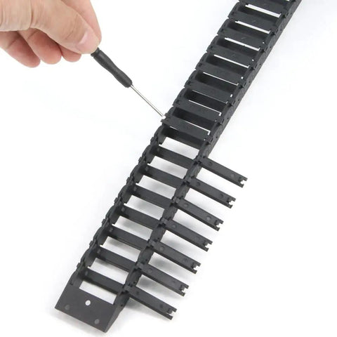 Open Type Drag Chain Cable Carrier 10x30mm, 1 Meter Length, black plastic, being assembled with a tool for CNC machines and 3D printers.