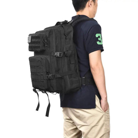 Person wearing 40L Tactical Backpack With MOLLE System, Heavy Duty Military Style 3 Day Assault Pack For Hiking And Camping, Water Resistant Army Backpack