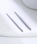 Pair of 16G Straight Piercing Taper Insertion Pins for Nose Septum Lip Rings in a 10 Piece Set on white surface