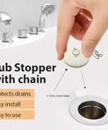 Top Shelf Rubber Tub Stopper With Pull Chain For Bathroom Sink And Shower Drain Cover Fits One Half To Two Inch, being placed in drain.