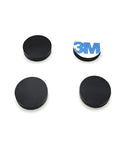 Four black half inch wide round silicone rubber bumper feet pads one eighth inch thick with adhesive backing shown on white background
