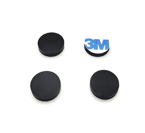 Four black half inch wide round silicone rubber bumper feet pads one eighth inch thick with adhesive backing shown on white background