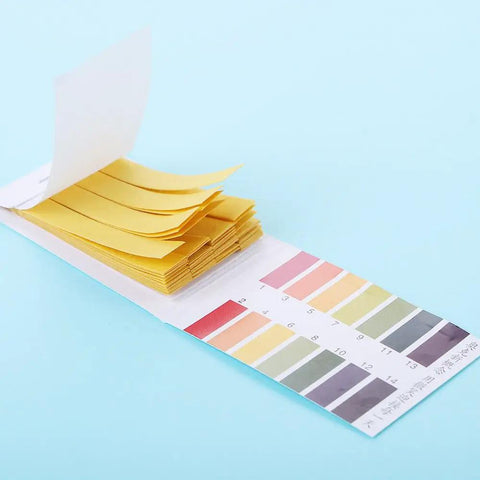 PH Test Strips From One To Fourteen Universal Litmus Indicator Eighty Strips with color chart on blue background