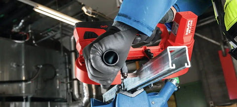 Using Cordless Band Saw With 22V Battery And LED Light For Cutting Up To 64 mm And 2 1/2 Inch Thick Materials in workshop setting.