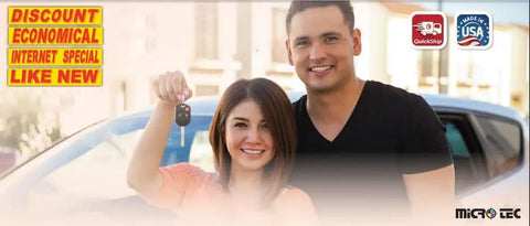 People holding car keys in front of a car with promotional stickers reading 'Discount Economical Internet Special Like New'