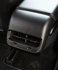 Fresh Matte Black Rear Air Vent Covers Plus Center Console Armrest Wraps For Tesla Model Y And Model 3 close-up view of rear air vent.