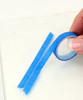 Close-up of blue tape from Rear Window Defroster Grid Repair Kit DIY Easy No Fuss Fix For Failing Defogger Lines Color Matched To Most
