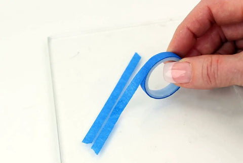 Close-up of blue tape from Rear Window Defroster Grid Repair Kit DIY Easy No Fuss Fix For Failing Defogger Lines Color Matched To Most