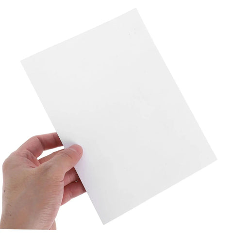 Person holding a single white sheet from Self Adhesive Wall Patch Kit With 12 Durable Vinyl Siding Patches 8.26 By 5.90 Inches Quick DIY Fix For Cracks And Holes On Walls Fences And Vinyl Siding At Home Office Or Store, showing size and material.