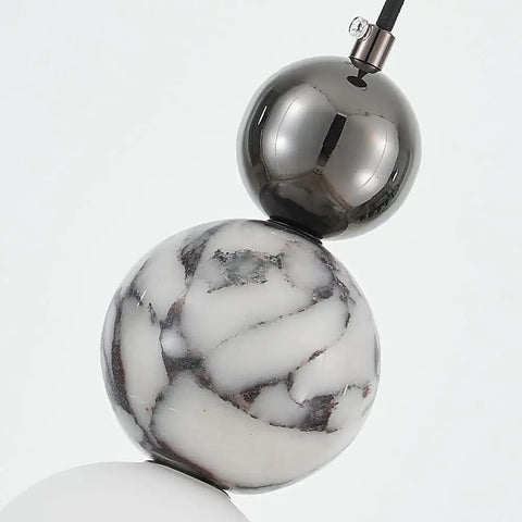 Aolyzmt Natural Alabaster Marble Pendant Light, Modern Cylinder LED Hanging Lamp with black gold sphere and natural marble detail.