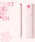 Two Pack Gel Pens With Cute Heart Design In Pink Ink Includes Four Extra Black Refills shown with packaging and pink floral decor.