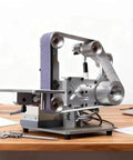 Tough As Nails 750W Belt Polisher And Grinder For Woodworking Trimming Sanding With Aluminum Body adjustable table on a workbench.