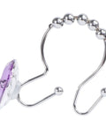 Close-up of purple double hooks glide shower curtain rings no fuss rust resistant stainless steel with decorative design.