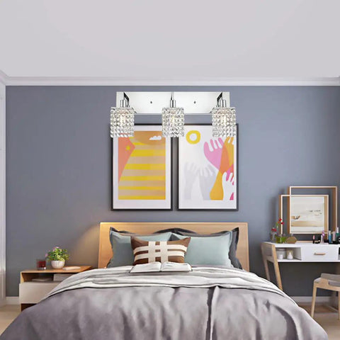 Three Light Crystal Vanity Light Fixture With Chrome Finish in bedroom, modern crystal wall sconce above bed with decor
