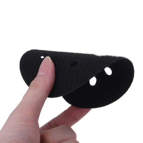 Person holding Pro Grade 5 Inch 8 Hole Hook And Loop Soft Sponge Buffer Pad For Sanding And Polishing, showing 8-hole design