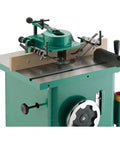 Built Like A Tank One Point Five Horsepower Woodworking Shaper Featuring Massive Twenty By Eighteen Inch Cast Iron Table And Dual Voltage Motor, close-up view of shaper with router bit.
