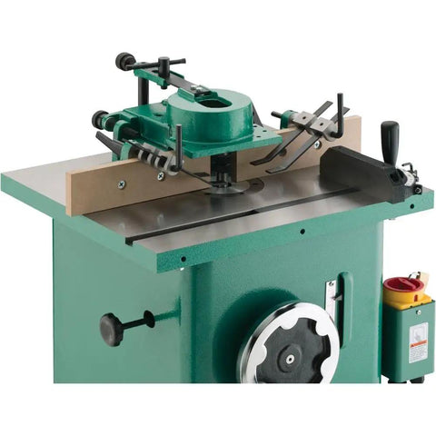 Built Like A Tank One Point Five Horsepower Woodworking Shaper Featuring Massive Twenty By Eighteen Inch Cast Iron Table And Dual Voltage Motor, close-up view of shaper with router bit.