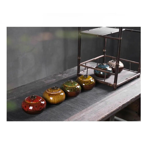 Sweet Ceramic Tea Canister For Loose Leaf Bin Plus Kitchen Pantry Setup, colorful airtight jars on a wooden table.