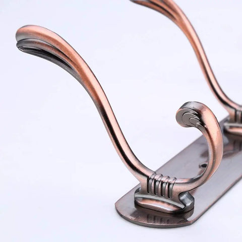 Close-up of Heavy Duty Stainless Steel Wall Coat Rack With Five Sturdy Hooks for Coats Hats Robes and Towels.