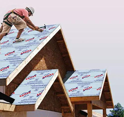 Roofer applying Heavy Duty Synthetic Roof Underlayment Four By Two Hundred Fifty Foot Roll on steep pitched roof.