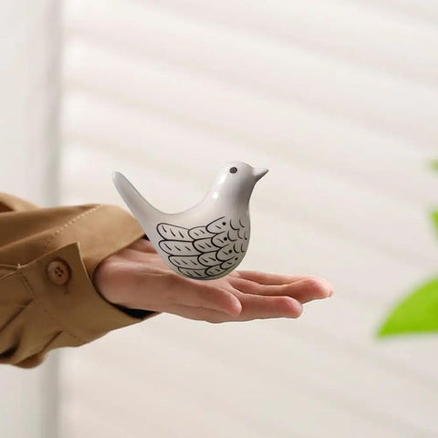 White ceramic bird decorative piece held in hand, part of Pretty Sweet Bird Toilet Bolt Covers Premium Ceramic Bathroom Screw Caps Set Of 2 Smooth Install Decorative Pieces Totally Spice Up Your Restroom In Fresh White.