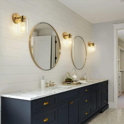 Bathroom with Brushed Gold Wall Sconces Set Of Two with Clear Glass Shades over vanity