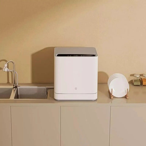 No Hookup Countertop Dishwasher That Sets Up In Minutes And Cranks Out Immaculate Loads Daily While Serving Up Sparkling Results With Fast High Temperature Wash And Dry Cycle on kitchen counter next to clean plates.