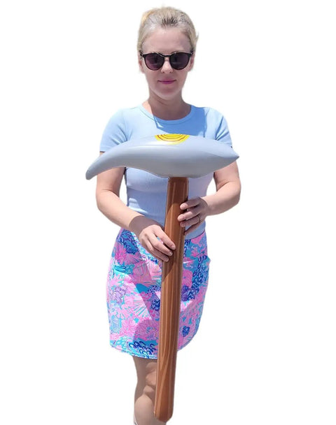 Person holding Inflatable Pick Axe Prop 33 Inch Wood And Silver Mining Tool For Party Decor And Themed Events Lightweight And Easy To Inflate.