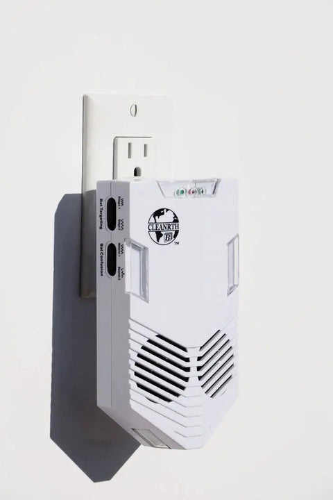 Advanced Ultrasonic Bat Deterrent System With BATONIC Tech plugged into wall outlet, white housing