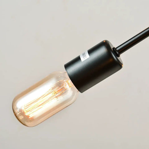 Close-up view of bulb on Vintage Metal Sputnik Chandelier With 18 Dimmable Lights In Black Finish, showing filament and black fixture.