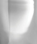 Abstract light and shadow on a wall, showcasing a soft, atmospheric gradient effect.