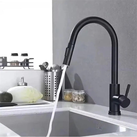 Black Pull Out Deck Mounted Flexible Hot Cold Stream Shower Modes Nozzle Faucet in modern kitchen with running water.
