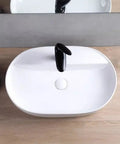 USZWBY Vessel Sinks Minimalist Ceramic Table Basin Home Hotel Bathroom Washbasin shown from above with black faucet.