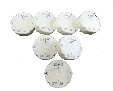 Top view of seven white plastic GM stepper motor end caps labeled X27 168 for repair kit