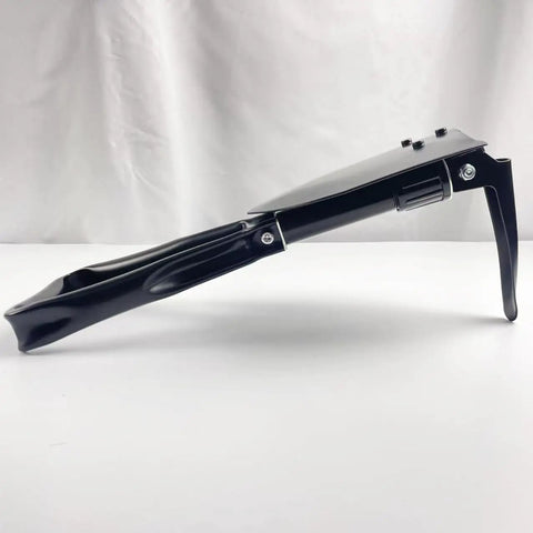 Side view of Tri Fold Survival Shovel With Pick Carbon Steel Tactical Entrenching Tool, folded with black finish, on a white background.