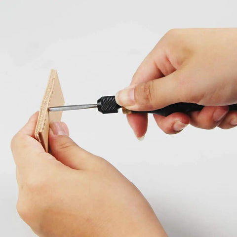 Person using Leathercraft 4 In 1 Awl Tool Set With Interchangeable Blades For Leatherworking on leather piece