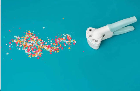 Multi Size Hole Punch For Leather, Paper, Fabric And More Rotates Through Five Hole Sizes with colorful confetti on teal background