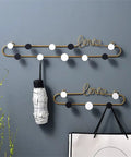 Gotta Have These Killer Wrought Iron Love Wall Hooks For Keys Hats And Scarves With A Totally Dope European Touch Black Metal Row Bar For Your Entryway Flex Size 39X8cm, with decorative black and white circles.