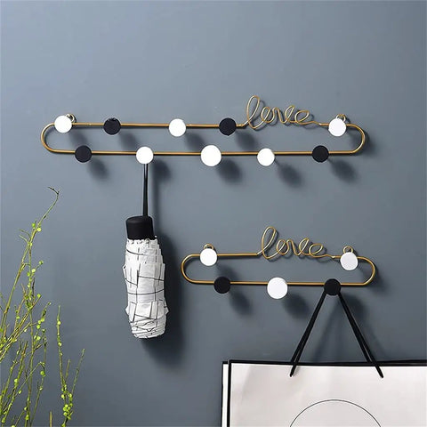 Gotta Have These Killer Wrought Iron Love Wall Hooks For Keys Hats And Scarves With A Totally Dope European Touch Black Metal Row Bar For Your Entryway Flex Size 39X8cm, with decorative black and white circles.