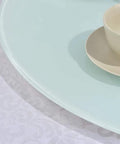 Close-up of Go To Kitchen Must Have Large Lazy Susan Serving Turntable With Glass Top showing edge detail on white tablecloth.