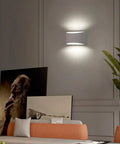 Aluminum Modern LED Wall Sconce Set Of 2 Dope Hardwired Up And Down Wall Mount Lights in a living room, soft cool white glow