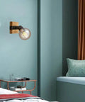 Slick Adjustable Metal And Wood Wall Sconce Vintage Industrial Farmhouse Light in a bedroom setting, featuring a bulb, mounted on wall.