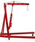 No Sweat Lifting Two Ton Folding Hydraulic Engine Hoist Cherry Picker with telescopic boom and steel base, red color.