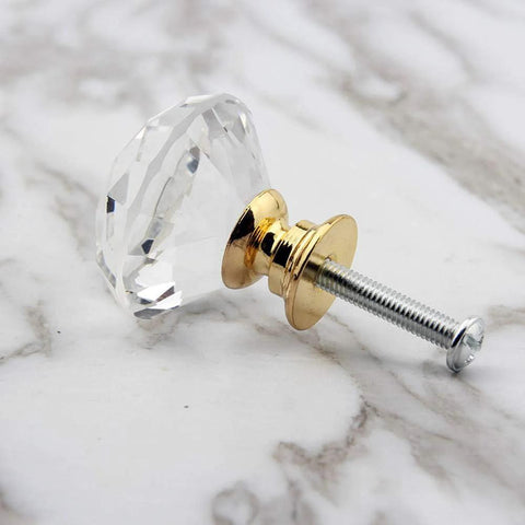 Single knob from 8 Pack Crystal Glass Cabinet Knobs With Gold Base Diamond Style Drawer Pulls, side view on marble surface.