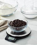 Digital Kitchen Scale With Large LCD Display And Tare Function Pro-Grade Measures In Pounds Ounces Grams Milliliters And Fluid Ounces Weighs Up To 11 Pounds Batteries Included Sleek Black And Stainless Steel with chocolate chips