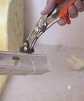 Close-up of NR1 Hand Nibbler with Built-In Waste Cutter cutting metal sheet, showing soft grip handles and precise nibbling action.