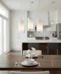 One Light Pendant Light With Clear And Frosted Glass Shade over kitchen island with modern brushed nickel finish