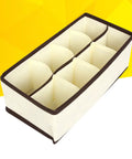 Top Tier Setup For Messy Drawers This Foldable Beige Drawer Organizer with eight compartments for socks and underwear.