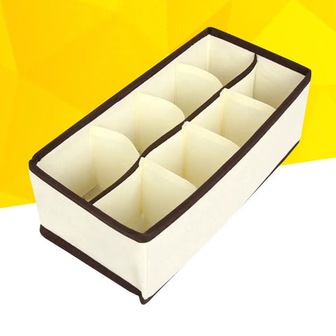 Top Tier Setup For Messy Drawers This Foldable Beige Drawer Organizer with eight compartments for socks and underwear.