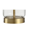 Close-up of the clear glass base with brass finish from Brass Gold And Clear Glass Table Lamp With White Linen Drum Shade.